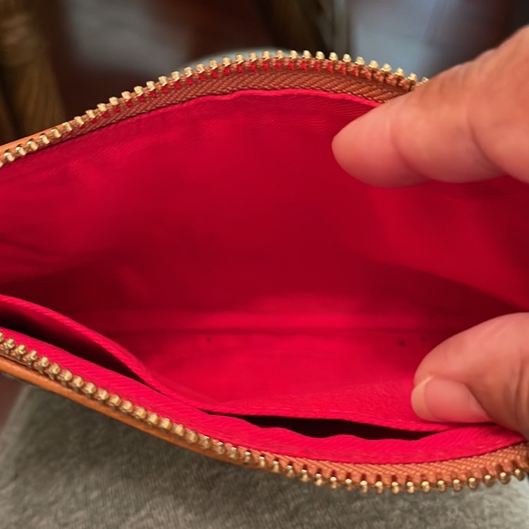 Dooney &Bourke wristlet pre owned has some flaws that are showed in pictures. - Picture 6 of 13